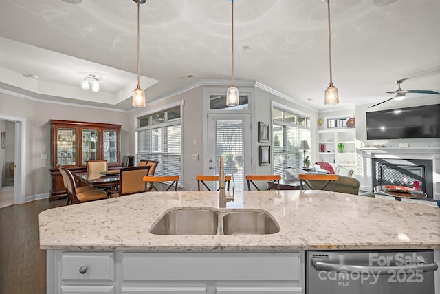 kitchen featuring white cabinets, pendant lighting, and stainless steel dishwasher