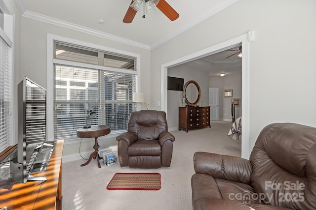 living room with ceiling fan, carpet floors, and crown molding