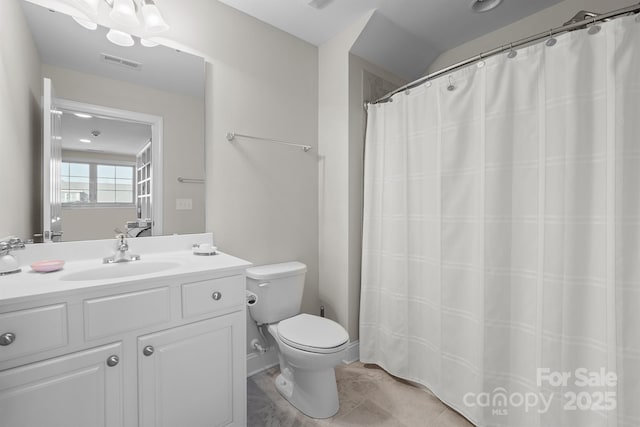 bathroom with tile patterned floors, vanity, and toilet