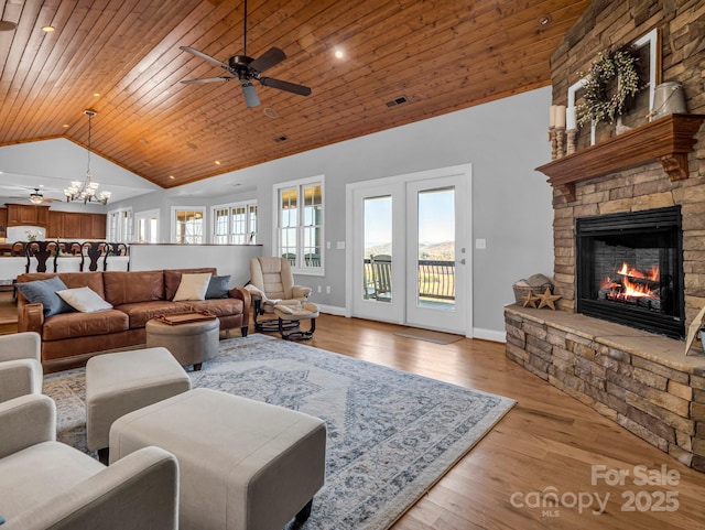 living room with a fireplace, vaulted ceiling, light hardwood / wood-style floors, ceiling fan with notable chandelier, and wood ceiling