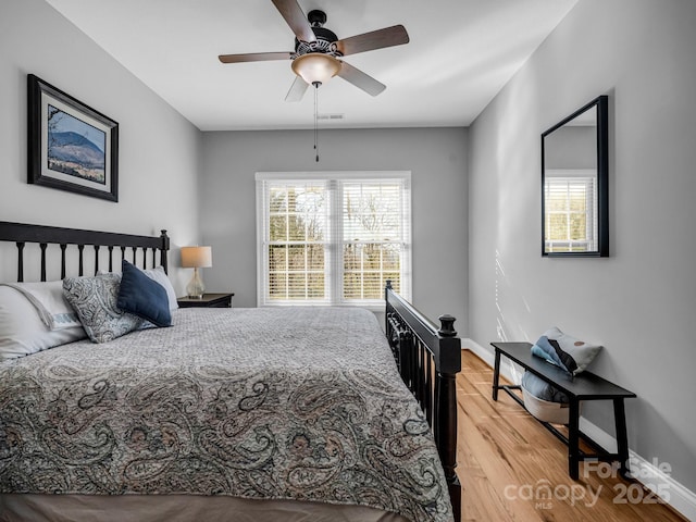 bedroom with wood-type flooring and ceiling fan