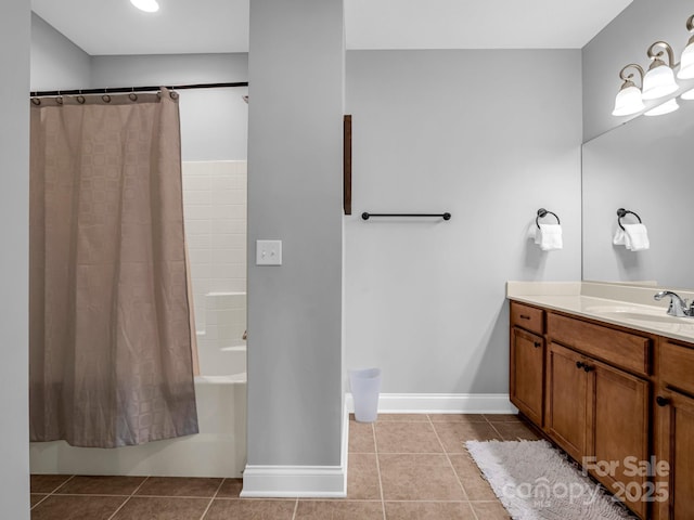 bathroom featuring tile patterned flooring, shower / bath combo with shower curtain, and vanity