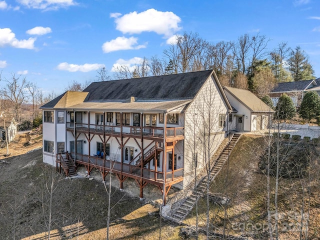 back of property featuring a chimney, stairway, and a wooden deck