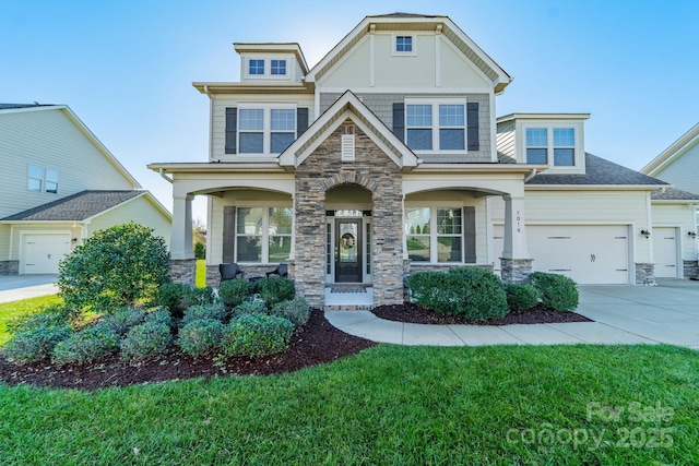 craftsman-style house featuring a front lawn and a garage