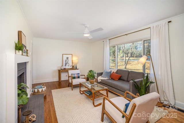 living room featuring ceiling fan and hardwood / wood-style floors