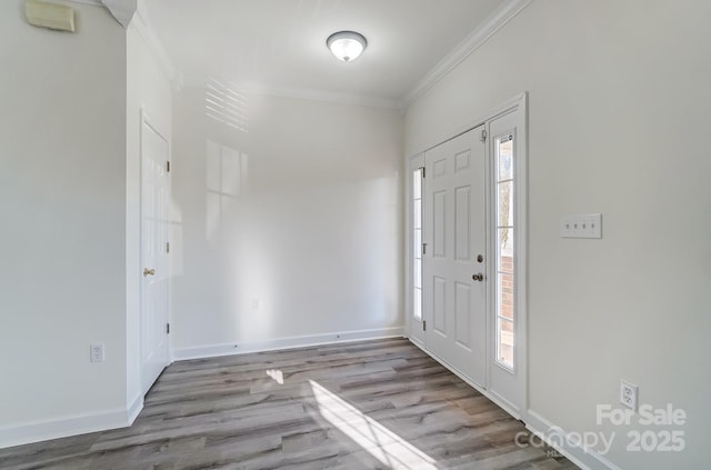 entrance foyer with crown molding and light hardwood / wood-style floors