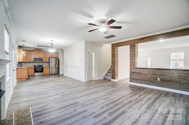 unfurnished living room with light hardwood / wood-style flooring and crown molding