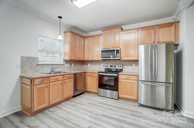 kitchen with sink, light hardwood / wood-style floors, pendant lighting, appliances with stainless steel finishes, and ornamental molding