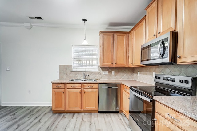 kitchen featuring ornamental molding, hanging light fixtures, stainless steel appliances, and sink