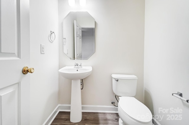 bathroom featuring hardwood / wood-style floors and toilet