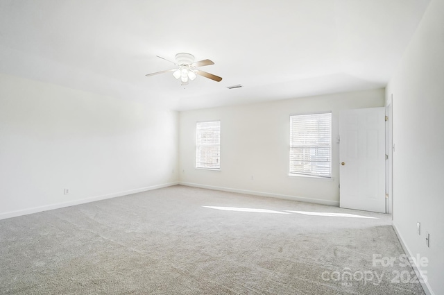 empty room featuring light colored carpet and ceiling fan