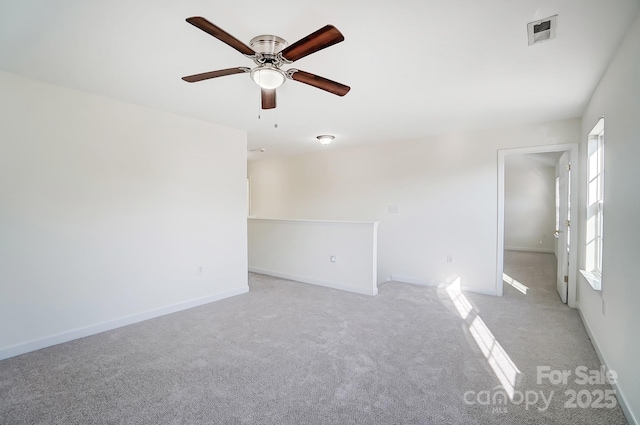 carpeted spare room featuring ceiling fan