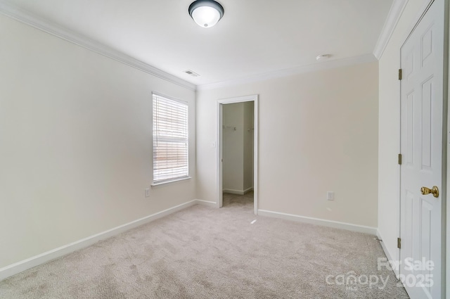 unfurnished bedroom featuring a closet, light colored carpet, and ornamental molding