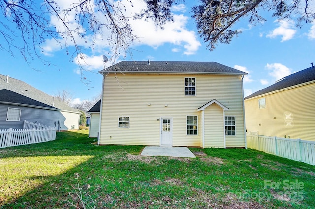 back of property with a yard and a patio area