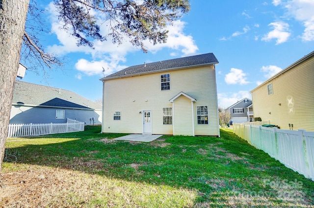 rear view of property featuring a patio area and a yard