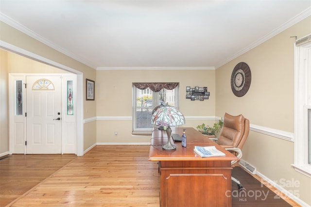 home office with light hardwood / wood-style floors and crown molding