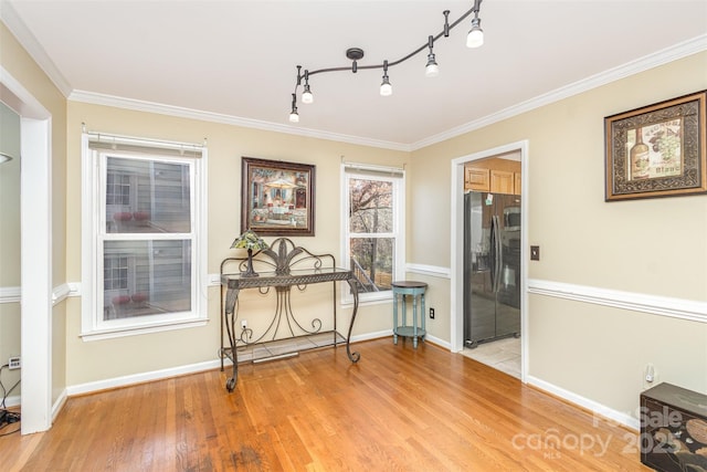 interior space with light hardwood / wood-style flooring and crown molding