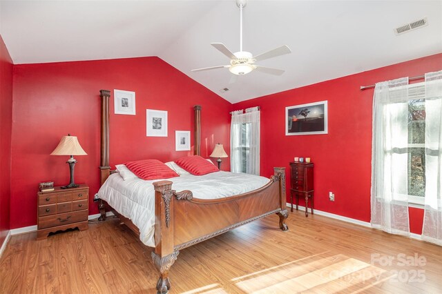 bedroom featuring hardwood / wood-style flooring, ceiling fan, and lofted ceiling