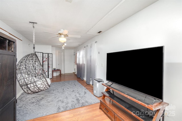 living room with ceiling fan and light hardwood / wood-style floors