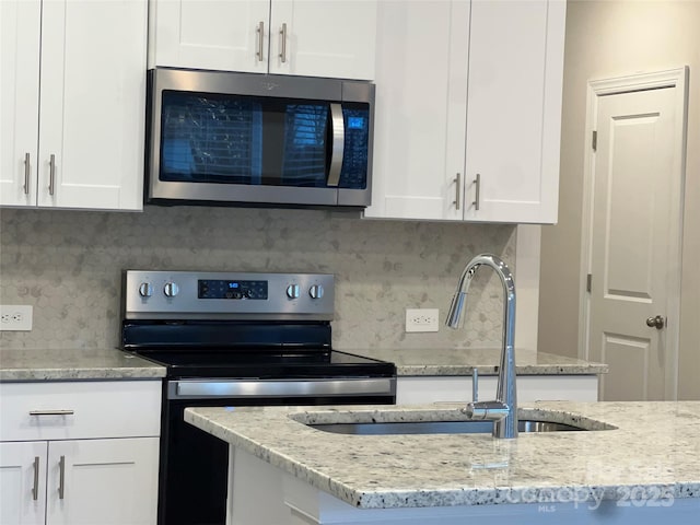 kitchen featuring white cabinetry, stainless steel appliances, and sink