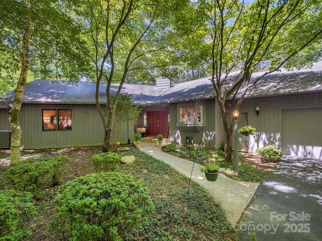 ranch-style house with central AC and a garage