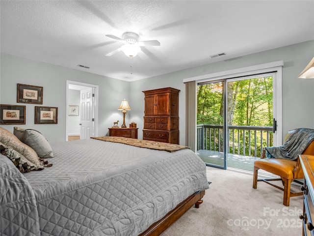 bedroom featuring light carpet, a textured ceiling, access to exterior, and ceiling fan