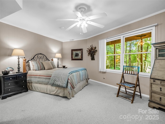 bedroom with ceiling fan, crown molding, and carpet floors