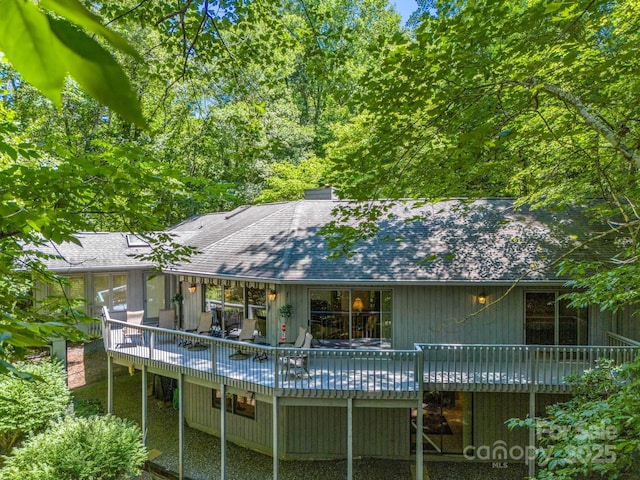 rear view of house featuring a deck and a sunroom