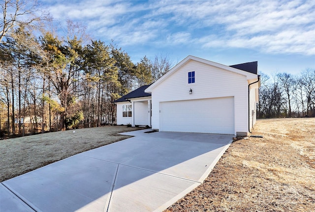 view of side of home featuring a garage