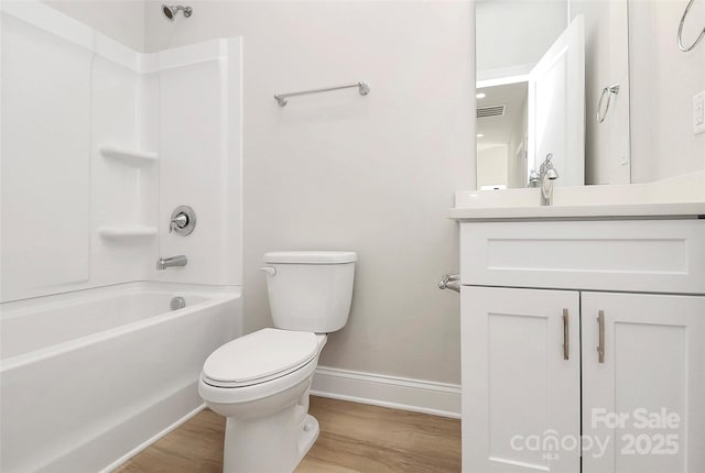 full bathroom featuring shower / bath combination, vanity, hardwood / wood-style floors, and toilet