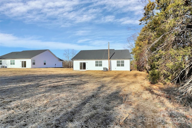 rear view of property with central AC unit