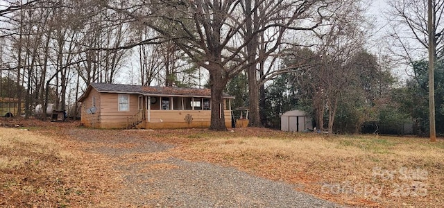 view of front of house with a storage shed