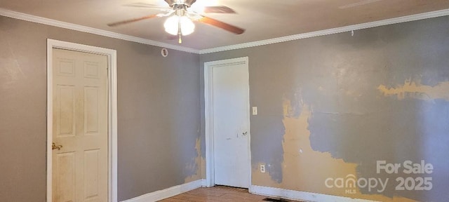 spare room featuring light hardwood / wood-style floors, ceiling fan, and crown molding