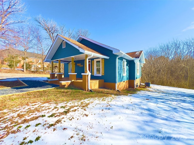 view of snow covered exterior with a porch