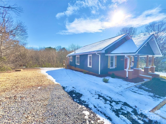 view of snow covered exterior with a porch