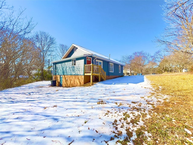 view of snow covered rear of property