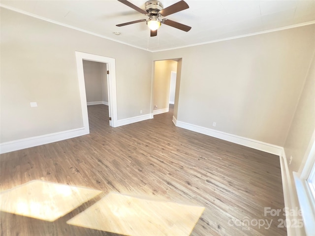 spare room featuring hardwood / wood-style floors, ceiling fan, and crown molding