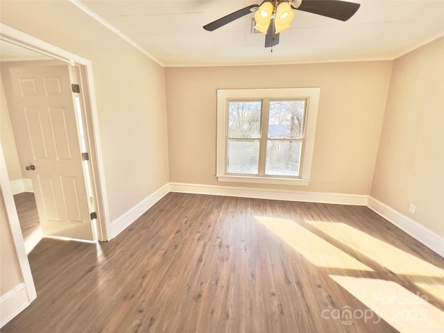 spare room featuring dark hardwood / wood-style flooring, ceiling fan, and ornamental molding