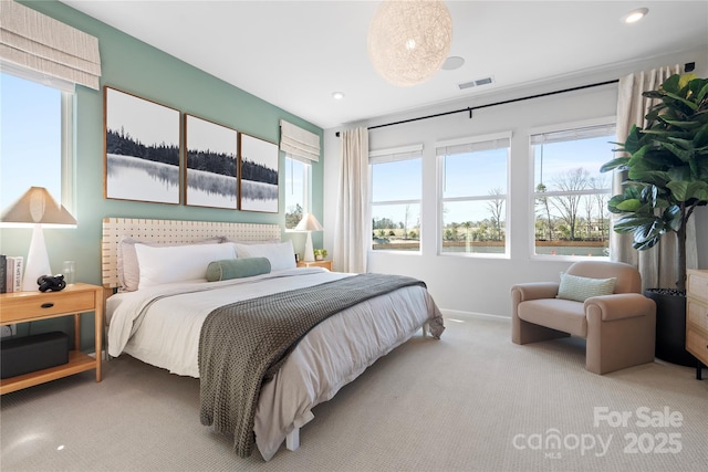 carpeted bedroom featuring visible vents and baseboards