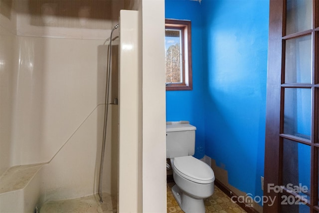 bathroom with walk in shower and toilet