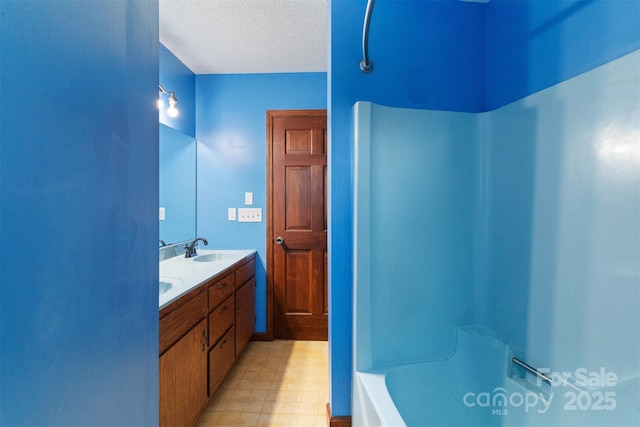 bathroom with vanity and a textured ceiling