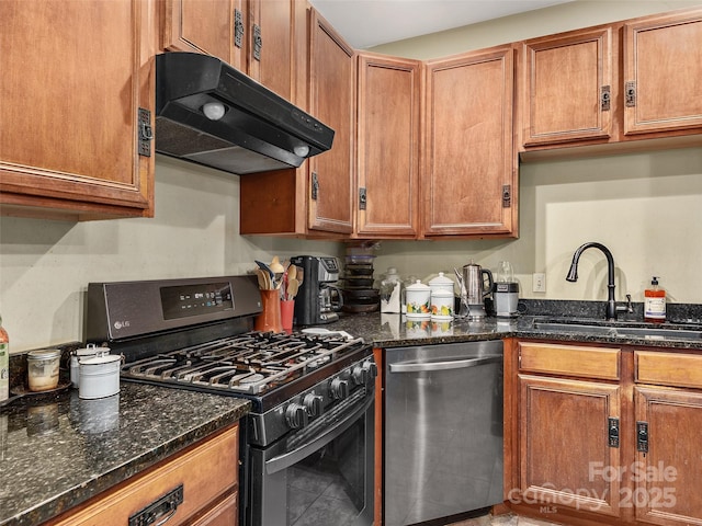 kitchen featuring black gas range, dark stone countertops, sink, and stainless steel dishwasher