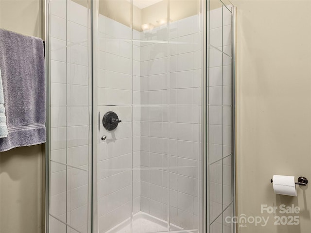 bathroom with a shower with door