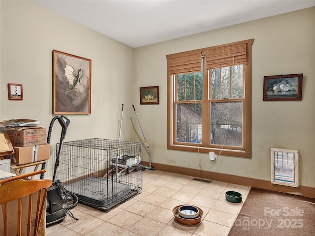 miscellaneous room with light tile patterned floors