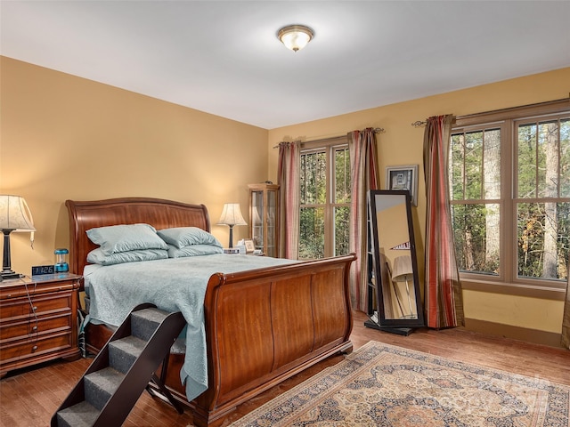 bedroom featuring wood-type flooring and multiple windows