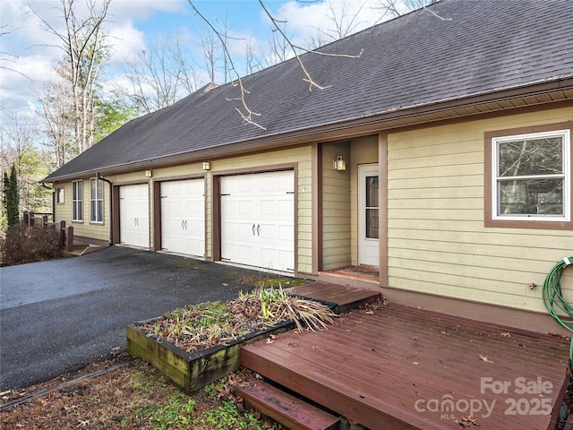 exterior space featuring a garage and aphalt driveway