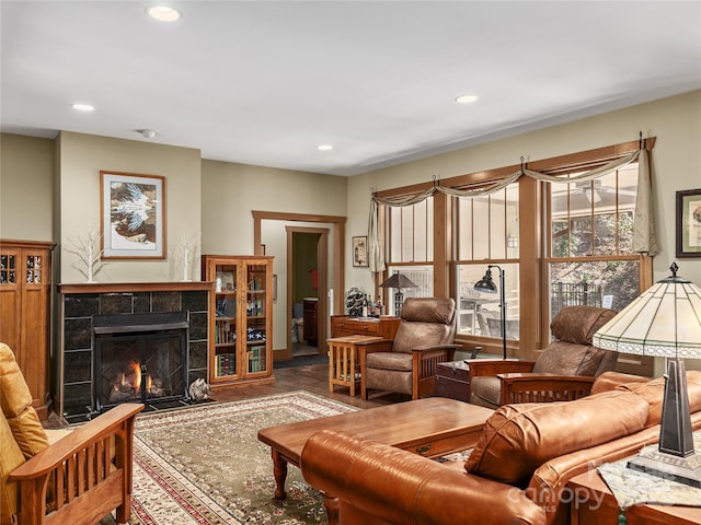 living room featuring a fireplace, wood finished floors, and recessed lighting