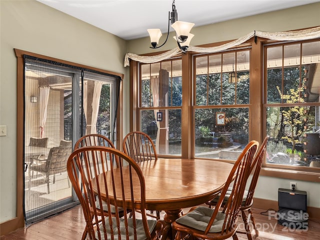 dining room with a chandelier and wood finished floors