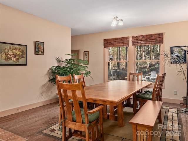 dining room with baseboards and wood finished floors