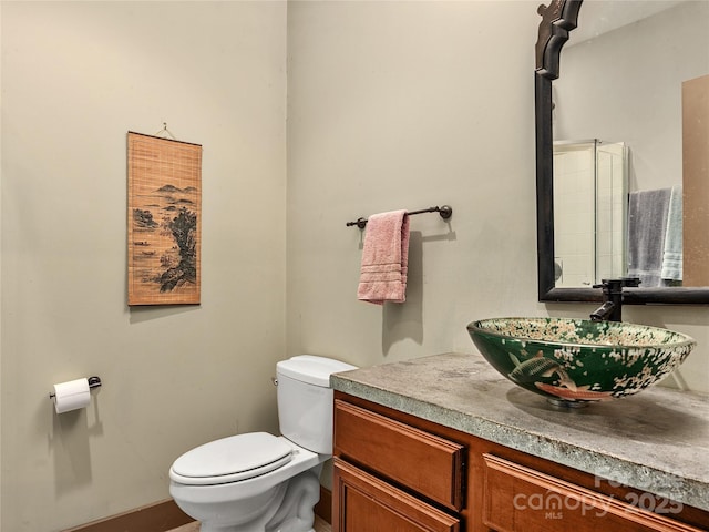 bathroom featuring toilet and vanity